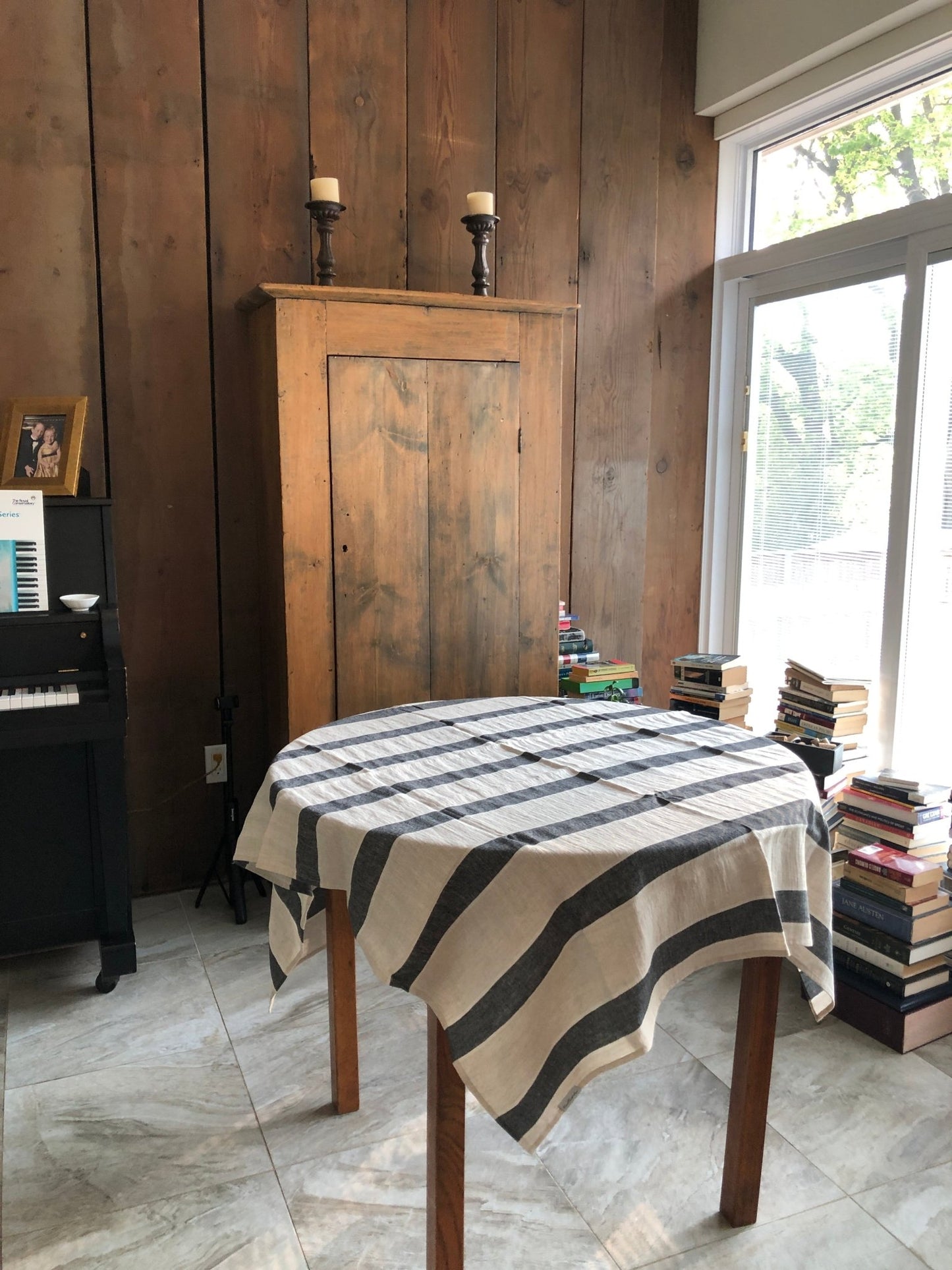 charcoal grey and natural flax Huckaback beach Towel used as tablecloth on round table in sunny room