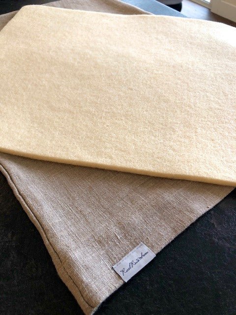 Wool dish drying mat insert resting on top of Natural Flax Linen Dish Drying Mat with Rural Route Seven logo brand label
