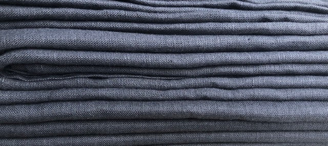 Close up of folded edge of a stack of textured Stonewashed European Linen Bath Towels in Dark Aubergine Purple from Rural Route Seven Simple Beauty, Every Day brand