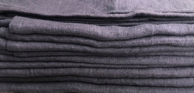 Close up of folded edge of a stack of textured Stonewashed European Linen Bath Towels in Dark Aubergine Purple from Rural Route Seven Simple Beauty, Every Day brand