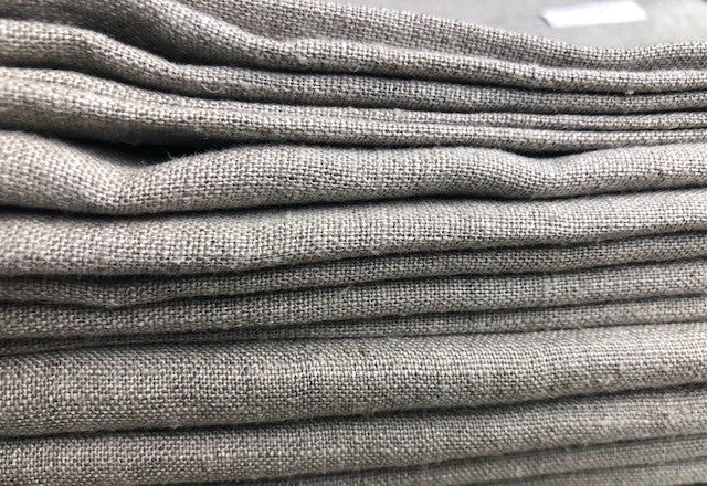 Close up of folded edges of stack of textured Linen Bath Towels in beige Natural Flax Linen from Rural Route Seven brand