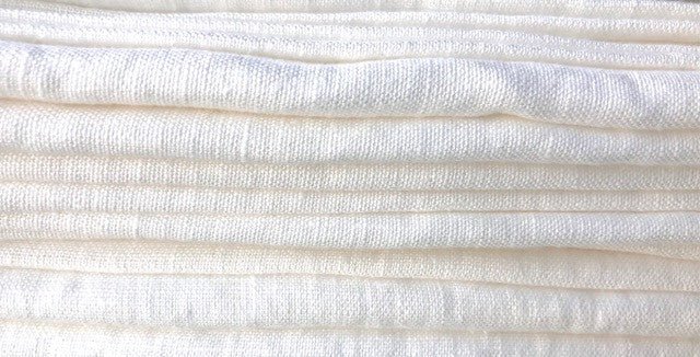 Close up of folded edge of a stack of textured Stonewashed European Linen Bath Towels in Off-White Linen from Rural Route Seven Simple Beauty, Every Day brand