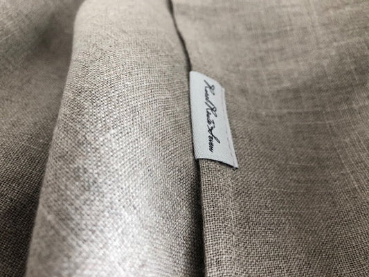 close up of textured natural linen with moody shadows neutrals